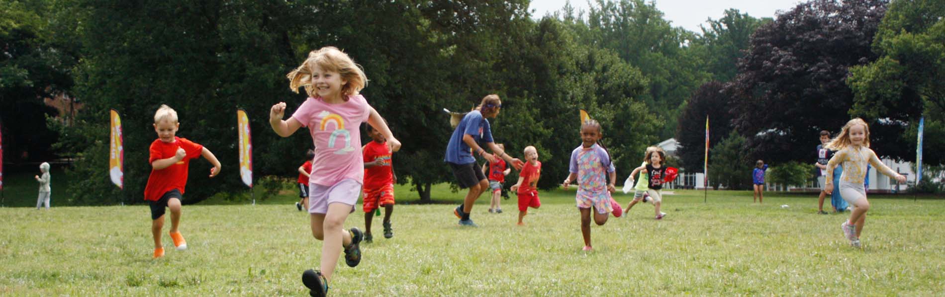 little children playing and running laughing outdoors