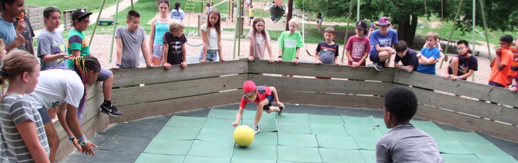 Lots of 14 to 15 year-olds playing ball outdoors