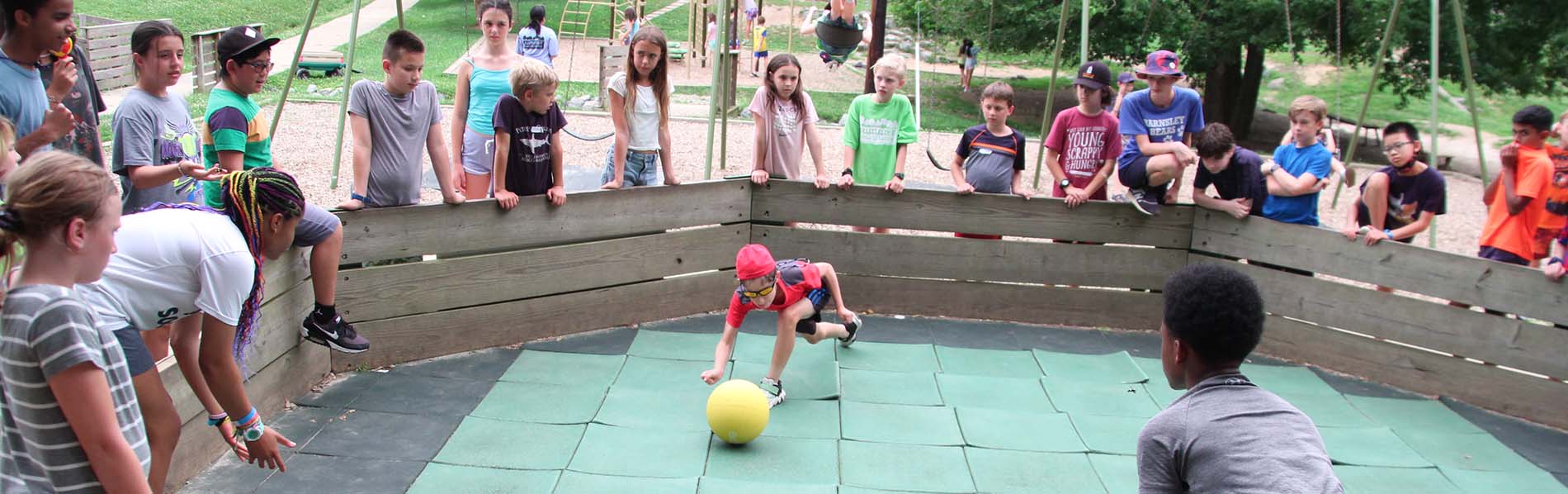 Lots of 14 to 15 year-olds playing ball outdoors