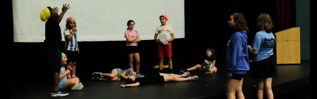 a group of kids acting out a play on stage