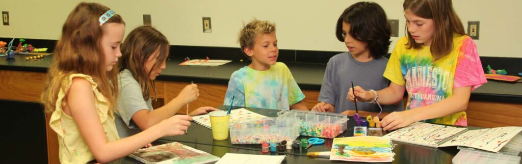 Five children doing art projects