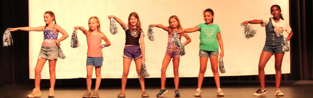 girls dancing w/ poms at a special event