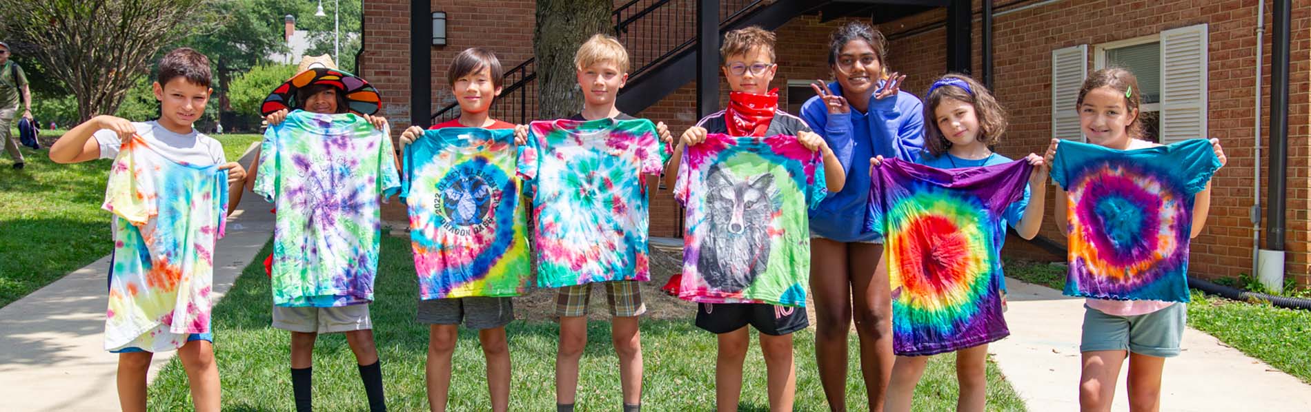 kids showing off their shirt coloring craft