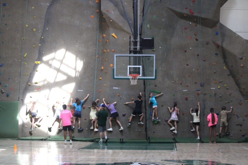 Trailblazer campers climbing the indoor rock wall at Summer at Sandy Spring
